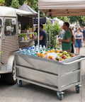 Heavy Duty Commercial Food Prep Cart With Slick Rolling Locking Casters Featuring Deep 304 Stainless Steel Soak Tank For No Sweat Busy Kitchen Grind Ready Setup filled with drinks and fruits at a busy market.