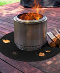Round Fire Pit Mat For Outdoor Hangouts, Fireproof, Waterproof Spark Shield under stove on wooden deck with logs