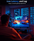 Person gaming in living room with focus on TV showing racing game, highlighting low latency and smooth experience.