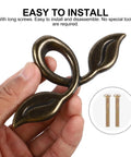 Hand holding zinc alloy cabinet handle from 4 Pack Zinc Alloy Cabinet Handles Set With Vintage Wardrobe Drawer Pulls Built To Last Rustproof Cupboard Door Knobs For Kitchen Cabinets And Furniture Hardware Easy Install Everyday Style.