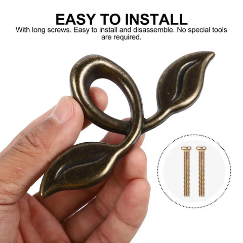 Hand holding zinc alloy cabinet handle from 4 Pack Zinc Alloy Cabinet Handles Set With Vintage Wardrobe Drawer Pulls Built To Last Rustproof Cupboard Door Knobs For Kitchen Cabinets And Furniture Hardware Easy Install Everyday Style.