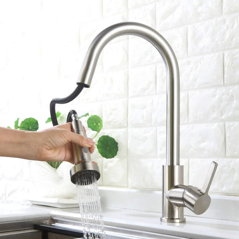 Hand pulling down faucet replacement head with two function spray for G1 2 kitchen sink, showing chrome spray in water stream mode.