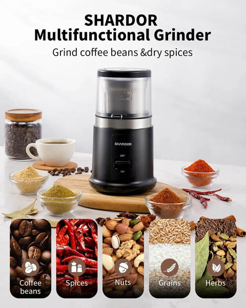 One Touch Coffee And Spice Grinder With Removable Stainless Steel Cup For Coffee Beans Spices And Seeds Quiet Electric Dry Grinder Easy One Hand Operation Low Noise About 60 dB Black on a countertop with spices and coffee beans