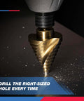 Brass-colored step drill bit with spiral grooves mounted in a drill chuck, metal shavings around