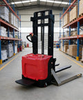High Capacity Industrial Grade Pallet Stacker With Straddle Legs Slick Warehouse Lifter For Factory Cargo Transfer And Portable Workshop Material Handling No Sweat Gear in warehouse aisle.