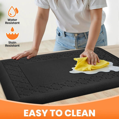 Ultra Thick Four Fifths Inch Cushy Memory Foam Kitchen Mat Non Slip Anti Fatigue Rug For Standing At The Sink Or Desk Waterproof And Stain Resistant Floor Pad 17.3 By 24 Inches Black, being wiped with a cloth
