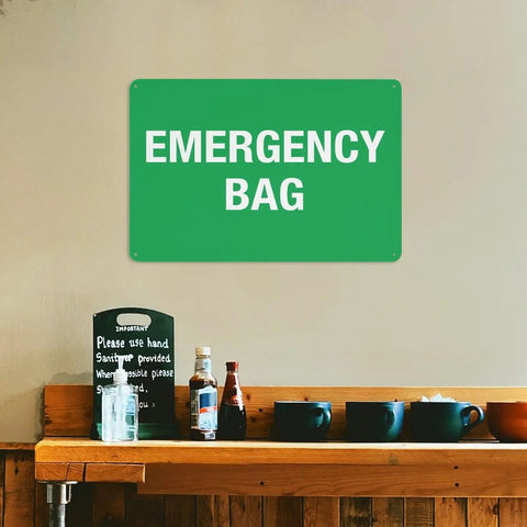 Emergency First Aid Sign For Outdoor Use 8 By 12 Inch Wall Decor For Home Office Shop Warehouse Factory Workplace Storage Zone Marker Plaque High Visibility Aluminum Notice With Bold Text For Clear Readability shown on wall above wooden shelf with bottles and cups.
