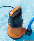 Rock Solid Submersible Water Pump 1 Horsepower 4300 Gallons Per Hour in pool water with hose attachment for drainage.