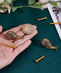 Brass Snail Cabinet Knobs Set Gold Animal Drawer Knobs With Screws Vintage Retro Vibe shown in hand next to a coin