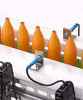 Fiber Optic Sensor Amplifier with HD LED Dual Digital Display monitoring orange bottles on a production line for industrial automation