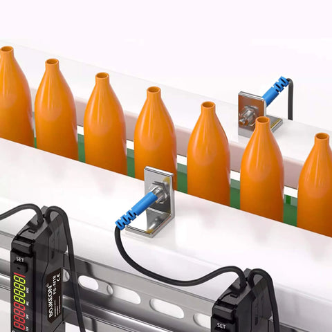 Fiber Optic Sensor Amplifier with HD LED Dual Digital Display monitoring orange bottles on a production line for industrial automation