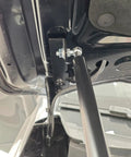Close-up of Toyota RAV4 2026 2027 front hood lift supports, showing heavy-duty stainless steel hydraulic struts installed
