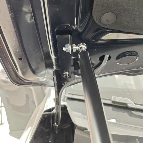 Close-up of Toyota RAV4 2026 2027 front hood lift supports, showing heavy-duty stainless steel hydraulic struts installed