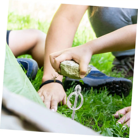 10 Pack Tent Pole Connectors With Single Needle Ring For Quick Setup And Takedown being installed in grassy area with hammer