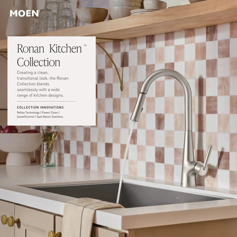 Top Shelf Pulldown Kitchen Faucet In Slick Spot Resist Stainless Steel with 360 swivel spray wand over a sink.