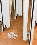 Heavy Duty 4 Piece Bi Fold Closet Door Hardware Kit With Top Roller Pivot Set In Modern White Finish Built For Super Smooth Glide And Rock Solid Performance On Interior Folding Doors Great For Quick Repairs And Maintaining Awesome Door Style Day, white bi-fold door hardware set on wood floor
