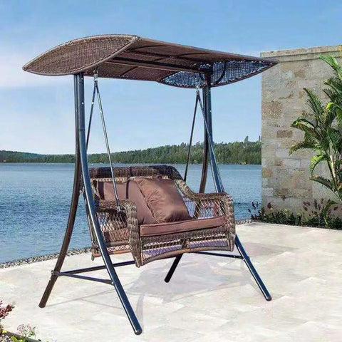 Outdoor swing bench with canopy by the lake.