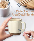 Hands using a stick from the 30 Piece Double Ended Sanding Sticks For Tiny Nooks And Holes, Pro Grade Fine Detail Polish Kit on a mug.