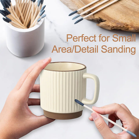Hands using a stick from the 30 Piece Double Ended Sanding Sticks For Tiny Nooks And Holes, Pro Grade Fine Detail Polish Kit on a mug.