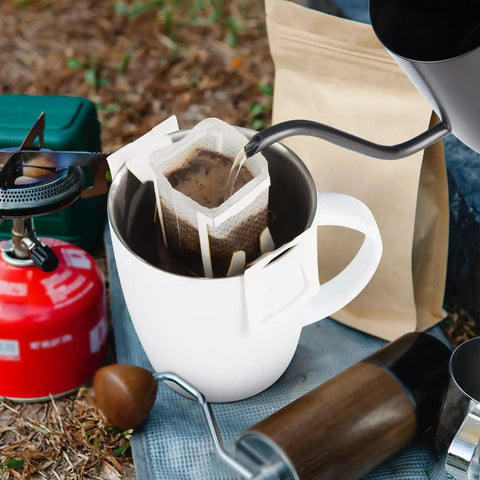 Go To Portable Coffee Filter Bags With Hanging Ear Design in use over white cup during camping