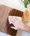 Applying Deep Penetrating Food Grade Butcher Block Conditioner For Hardwood And Bamboo Surfaces on a wooden board