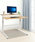 Heavy Duty Dual Tier Standing Desk With Smooth Crank Lift Tough Locking Wheels And Roomy Carbon Steel Desktop For Home Office Boss Moves That Roll Right Through The Grind in a bright room with monitor and keyboard.