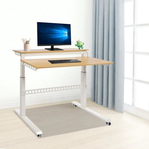 Heavy Duty Dual Tier Standing Desk With Smooth Crank Lift Tough Locking Wheels And Roomy Carbon Steel Desktop For Home Office Boss Moves That Roll Right Through The Grind in a bright room with monitor and keyboard.