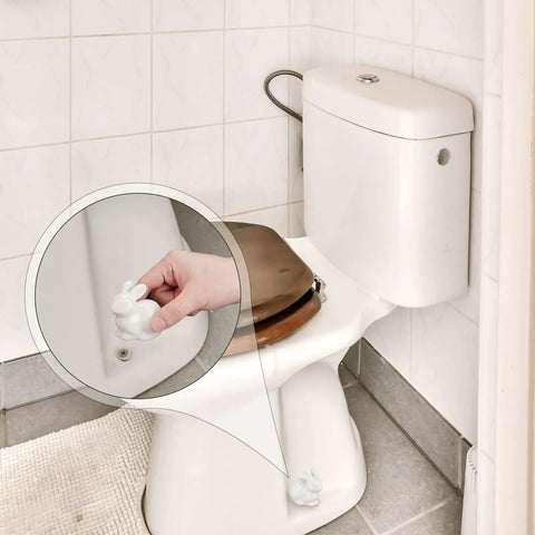 Two Pieces Rabbit Shaped Ceramic Toilet Bolt Covers Set For Bathroom Decor installed on white toilet, close-up view.