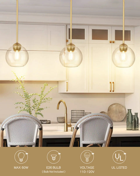 Gold Finish Industrial Pendant Light With Clear Glass Globe Shade over kitchen island