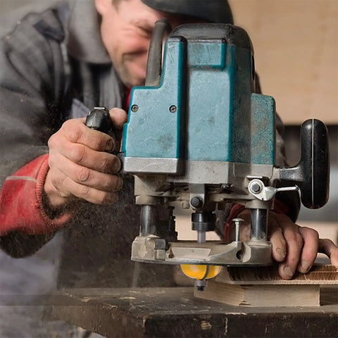 Carpenter using router with Router Bits Set 50 Piece, One Quarter Inch Shank, Tungsten Carbide Bits For Woodworking.