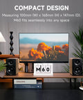 M60 Desktop Bluetooth Speaker With 66W RMS Output, oak finish, placed beside a monitor on a desk, highlighting compact design.