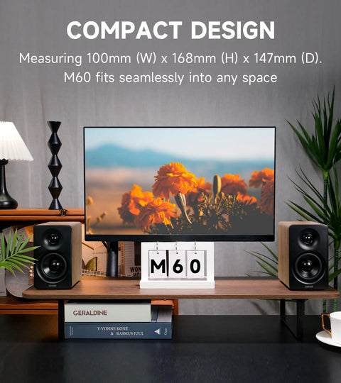 M60 Desktop Bluetooth Speaker With 66W RMS Output, oak finish, placed beside a monitor on a desk, highlighting compact design.