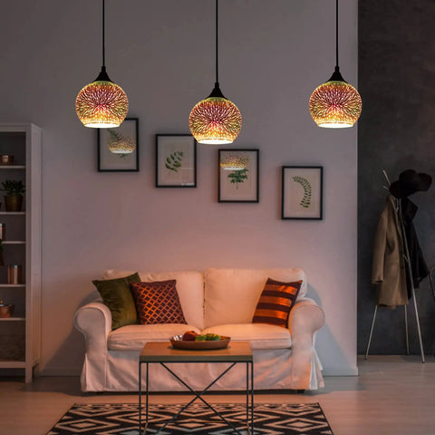 Set of 3 Modern Glass Pendant Lights With Colorful 3D Firework Design illuminating a cozy living room over a sofa.