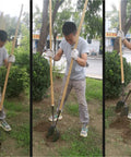 Heavy Duty Manual Post Hole Digger Featuring Sturdy Wood Handle And Razor Sharp Blades in use breaking tough clay soil.