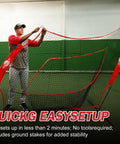 Man setting up Portable 7x7 Baseball Net For Batting And Pitching, Oversized Hitting Net With Carry Bag in an indoor space.