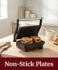 Elite Gourmet EPN-2976 2-in-1 Panini Press & Indoor Grill Made From Durable Stainless Steel cooking two grilled sandwiches.