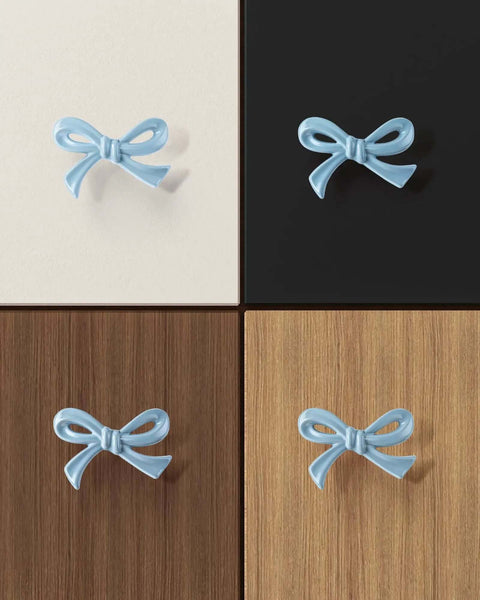 Blue Bow Dresser Knobs 4 Pack Small Decorative Cabinet Drawer Pull Handles mounted on varied wood and black surfaces