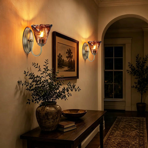 Vintage Glass Wall Sconces Set of 2,Aged Brass Bathroom Vanity Lighting illuminating a wall with amber flower glass shades.