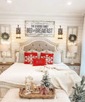 Bedroom with Rustic Oil Rubbed Bronze Wall Light Fixtures and Glass Shades flanking a vintage bed, farmhouse style decor.