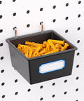 Slick Shop Pegboard Organizer And Hook Lock Kit With Heavy Duty Storage Bins holding yellow fasteners on a pegboard.