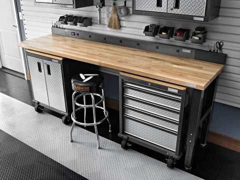 Heavy Duty Chrome Garage Work Stool With Double Ring Leg Construction, 300 Lb Capacity, beside a workbench in an organized garage