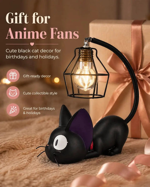 Jiji Black Cat Night Light Inspired by Kiki's Delivery Service beside a gift box on a plush surface, cozy resin desk bedside lamp