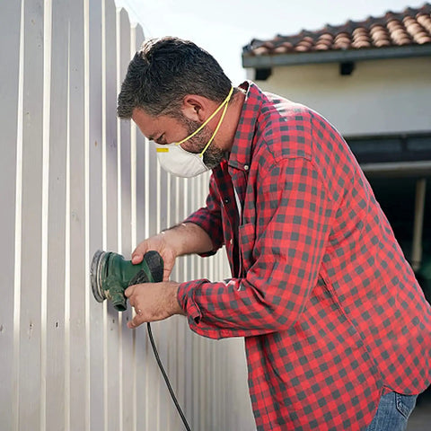 Person using angle grinder with Eight Pack Four Inch Wire Wheels For Angle Grinders With Twist Knot Carbon Steel Wire Brushes