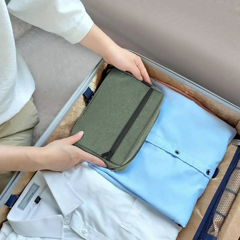 Mens Toiletry Bag For Travel And Grooming placed in suitcase with clothes, Army Green Travel Pouch for Shaving and Skincare Essentials