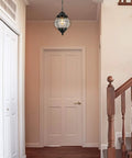 Outdoor Pendant Lights With Farmhouse Style Black Metal Hanging Porch Fixture And Clear Bubbled Glass Globe Inside An Iron Cage Frame For Rustic Vibe Exterior Lantern For Gazebo Patio And Entryway hanging in hallway.