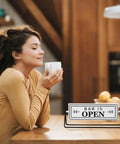 Smooth Flipping Open Closed Sign, Handmade Metal Counter Decor For Your Cozy Home Bar Or Office Coffee Spot With Black Stand And Embossed Lettering Straight Up Real Deal on a kitchen countertop.