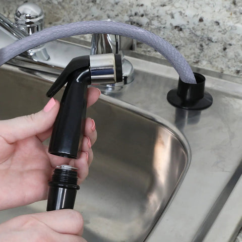 Built Tough Replacement Kitchen Faucet Spray Hose Coupled With 48 Inch Heavy Vinyl Line and Smooth Swivel Joint Black Handheld Sprayer being held.