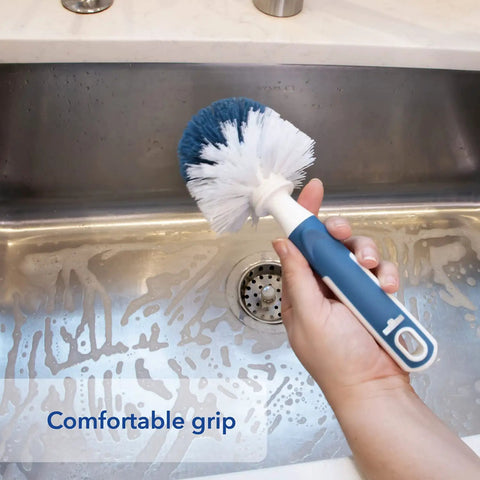 Heavy Duty Sink And Dish Scrub Brush With Safe Bristles, Perfect For Pots And Pans, Knocks Stubborn Food Right Off, Super Handy Kitchen Cleaning Tool That Handles Drains Like A Champ in hand over a soapy sink.