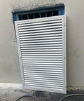 Solid Louvered Vent Access Panel Aluminum Recessed Magnetic Hatch For Drywall Attic Walls installed on a wall.