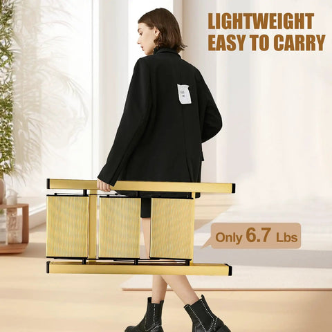 Foldable 3 Step Stool Ladder In Gold Aluminum For Kitchen And Closet Ultra Lightweight With 330 Lb Capacity Anti Slip Wide Pedals Portable For Kids And Adults No Assembly Required Space Saving Design Folded Thickness 1.9 Inches woman carrying folded gold aluminum ladder, only 6.7 lbs